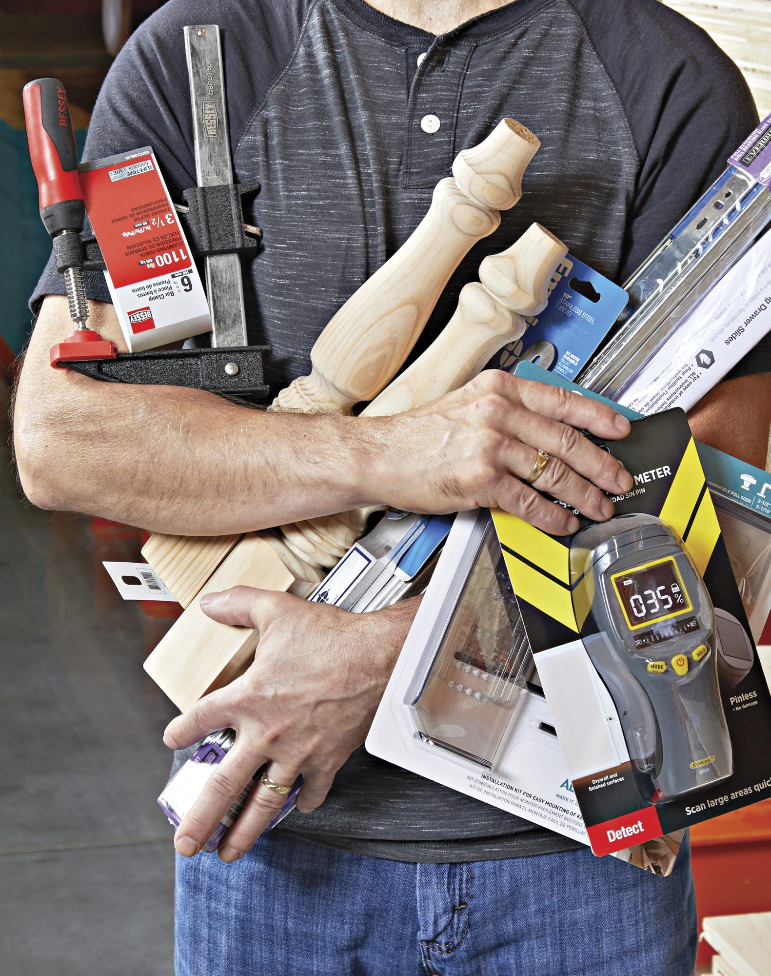 Photo of man clutching items from a home center